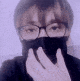 a person wearing glasses and a black face mask