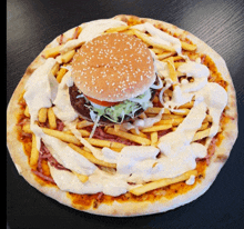 a pizza with a hamburger and fries on it