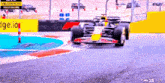 a race car is driving down a track with a yellow flag warning of track hazard