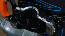 a close up of a metal object with a blue stripe on the bottom