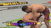 two men wrestling on a wrestling mat with the words islam wyd on the bottom
