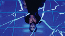 a blurry picture of a person standing in a dark room with a blue background