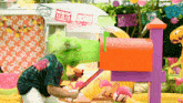 a man in a colorful shirt is opening a mailbox