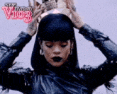 a woman holding a crown on her head with the letters vio3 on the bottom