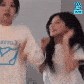 a couple of women are standing next to each other and dancing in a room .