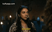 a woman with a nose ring is talking to another woman and says `` see what ? ''