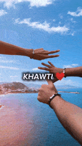 a couple 's hands are reaching out towards each other with the word khawti written above them