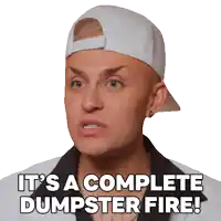 a man wearing a white hat and a white jacket says it 's a complete dumpster fire