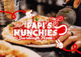 a sign for papi 's munchies sourdough pizza shows a person cutting a pizza