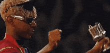 a man wearing sunglasses and a shirt that says ambiguity