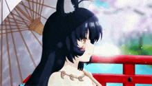 a girl with cat ears is holding an umbrella and smiling