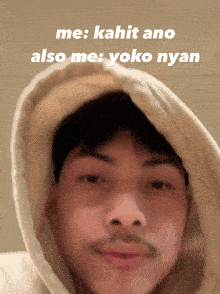 a man wearing a hooded sweatshirt with the words me kahit ano also me yoko nyan