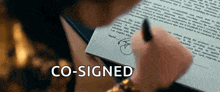 a person is signing a document with the word co-signed above it