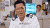 a man in a white uniform with a blue and white stripe on the shoulder has chinese writing on his chest