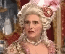 a woman is wearing a wig and pearls and making a funny face .