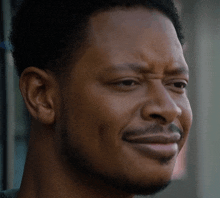 a close up of a man 's face with his mouth open
