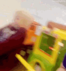 a blurry picture of a child playing with a toy truck with the words " the next big thing " at the top