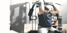 a man is doing exercises on a machine in a room .