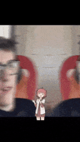 a blurry picture of a girl standing in front of a man with glasses