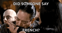 a man is licking a woman 's face with a knife while someone says " did someone say french " .