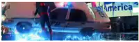 a man in a superhero costume is standing in front of a police car that says pd on it