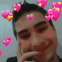 a man with pink hearts on his head and a hand on his chin