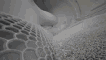 a close up of a gray carpet in a room with a geometric pattern .