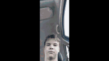 a blurry picture of a person driving a car with a bandage on their arm