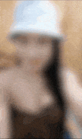a blurry picture of a woman wearing a white hat with the letter s on it