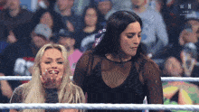 two women in a wrestling ring with the letters n in the corner