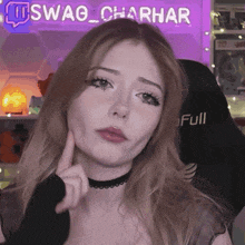 a woman is making a face in front of a sign that says swag charhar