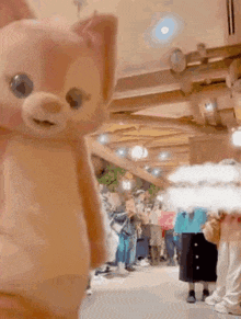 a stuffed animal is standing in a crowded room .