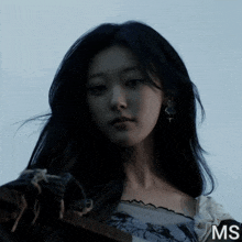 a close up of a woman 's face with the letters ms in the corner
