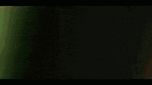 a blurry picture of a person wearing green glasses