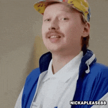 a man with a mustache and a hat is wearing a blue vest and a white shirt .