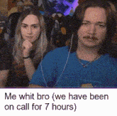 a man and a woman are sitting next to each other in a room .