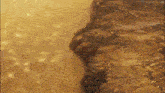a painting of a rocky cliff with grass growing on it