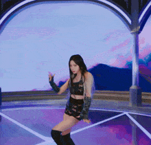 a woman in a black crop top and shorts is dancing