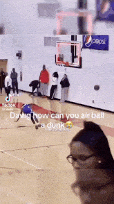 a basketball game is being played in front of a pepsi ad