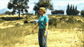 a woman in a blue shirt and jeans stands in a field