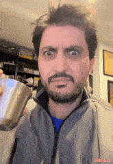 a man with a beard is holding a stainless steel cup that says think jules on the bottom