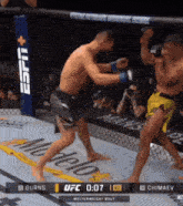two men are fighting in a ufc ring with 0:07 left in the match