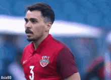 a man in a red jersey with the number 3 on it