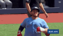 a baseball player for the blue jays runs on the field