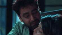 a man is hugging a woman who is laying down