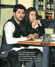 a man and a woman sit at a table with aishuu written on the bottom right