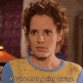 a woman says you 're not going away in a yellow and blue sweater