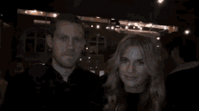 a man and a woman are toasting with martinis