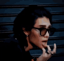a man wearing sunglasses is sticking his tongue out .
