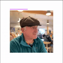 a man wearing a hat and a green jacket is sitting at a table